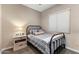 Cozy bedroom features a wrought iron bed frame and soft, neutral decor at 21283 E Camacho Rd, Queen Creek, AZ 85142