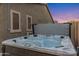 Private hot tub with jets for relaxation and therapeutic massage, situated in a peaceful backyard setting at 21283 E Camacho Rd, Queen Creek, AZ 85142