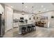 Well-lit kitchen with white cabinetry, stainless steel appliances, and an open design connecting to the dining area at 21283 E Camacho Rd, Queen Creek, AZ 85142