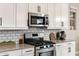 Modern kitchen showcasing white cabinets, stainless steel appliances, and subway tile backsplash for a clean and stylish look at 21283 E Camacho Rd, Queen Creek, AZ 85142