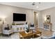 Neutral living room featuring a media center and tiled floors at 21283 E Camacho Rd, Queen Creek, AZ 85142