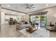 Spacious living room with a view to the backyard, modern furniture, and an open layout connecting to the kitchen at 21283 E Camacho Rd, Queen Creek, AZ 85142