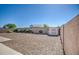 Expansive backyard featuring a gravel landscape, a storage shed, and a block wall for privacy at 21551 E Waverly Ct, Queen Creek, AZ 85142