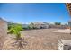 View of the backyard featuring gravel, a small patio, and a block wall fence at 21551 E Waverly Ct, Queen Creek, AZ 85142
