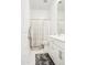 Well-lit bathroom featuring double vanity and shower with decorative curtain at 21551 E Waverly Ct, Queen Creek, AZ 85142