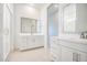 Bright bathroom with white cabinets, framed mirrors, walk-in shower, and chrome hardware at 21551 E Waverly Ct, Queen Creek, AZ 85142