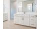 Bright bathroom featuring white cabinets, chrome hardware, and a large framed mirror above the vanity at 21551 E Waverly Ct, Queen Creek, AZ 85142