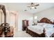 Bedroom featuring an ornamental dresser with a ceiling fan and tile floors at 21551 E Waverly Ct, Queen Creek, AZ 85142
