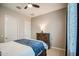 Spacious bedroom featuring a comfortable bed, a dresser, and neutral walls with white trim at 21551 E Waverly Ct, Queen Creek, AZ 85142