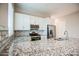 Close-up of a granite countertop with a stainless steel range and subway tile backsplash in kitchen at 21551 E Waverly Ct, Queen Creek, AZ 85142