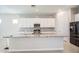 Well-appointed kitchen with white cabinets, granite countertops, and a large central island at 21551 E Waverly Ct, Queen Creek, AZ 85142