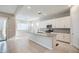 Stylish kitchen with an island, white cabinets, and a view into the adjacent living area at 21551 E Waverly Ct, Queen Creek, AZ 85142