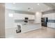 Contemporary kitchen boasts white cabinets, a granite island, and stainless steel appliances at 21551 E Waverly Ct, Queen Creek, AZ 85142