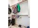 Convenient laundry room features modern washer and dryer with open closet space at 21551 E Waverly Ct, Queen Creek, AZ 85142