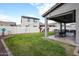 Spacious backyard features a covered patio, large grassy area, and desert-style landscaping at 2158 N 212Th Ave, Buckeye, AZ 85396