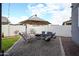 Low maintenance backyard with desert landscaping, seating and grill at 2158 N 212Th Ave, Buckeye, AZ 85396