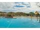 Community pool with water features and lounge chairs surrounded by desert landscape at 2158 N 212Th Ave, Buckeye, AZ 85396