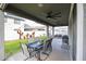 Inviting covered patio with ceiling fans, dining area, and views of the landscaped backyard at 2158 N 212Th Ave, Buckeye, AZ 85396