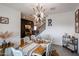 Elegant dining room with decorative light fixture, staircase, and dark accent wall at 2158 N 212Th Ave, Buckeye, AZ 85396