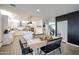 Bright dining room with stylish wood table and views of kitchen, perfect for Gathering gatherings and entertaining at 2158 N 212Th Ave, Buckeye, AZ 85396
