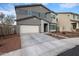 Two-story home with attached garage, manicured lawn and neutral stucco exterior at 2158 N 212Th Ave, Buckeye, AZ 85396