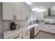 Well-lit kitchen boasting modern stainless steel appliances, sleek white cabinetry, and elegant countertops at 2158 N 212Th Ave, Buckeye, AZ 85396