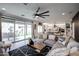 Open-concept living room flows seamlessly into the kitchen, creating a perfect space for modern living and entertaining at 2158 N 212Th Ave, Buckeye, AZ 85396