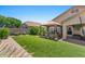 Enjoy the serene backyard, featuring lush artificial turf and a shaded hot tub for relaxation and recreation at 21720 E Domingo Rd, Queen Creek, AZ 85142