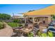 Enjoy a backyard oasis with a covered patio, outdoor kitchen, fire pit, seating, and well-manicured lawn at 21720 E Domingo Rd, Queen Creek, AZ 85142