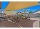 Relax in the spacious backyard featuring a built-in grill, dining area, and cozy seating around a fire pit at 21720 E Domingo Rd, Queen Creek, AZ 85142
