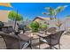 Enjoy outdoor living with a charming seating area centered around a modern fire pit in the backyard at 21720 E Domingo Rd, Queen Creek, AZ 85142