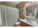 Stylish bathroom with decorative mirror, modern sink, and charming macrame wall art at 21720 E Domingo Rd, Queen Creek, AZ 85142
