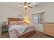 Cozy bedroom featuring a ceiling fan, a window, and a comfortable bed with stylish bedding at 21720 E Domingo Rd, Queen Creek, AZ 85142