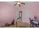 Bright bedroom featuring plush carpet, ceiling fan, and exercise equipment at 21720 E Domingo Rd, Queen Creek, AZ 85142