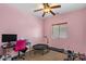 Bright bedroom includes ceiling fan, plush carpet, natural light, and exercise equipment at 21720 E Domingo Rd, Queen Creek, AZ 85142