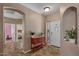Inviting foyer with neutral walls, tile floors, and an accent cabinet creating a warm entrance to the home at 21720 E Domingo Rd, Queen Creek, AZ 85142