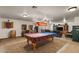 Spacious game room with a pool table, pinball machines, darts and comfortable seating area at 21720 E Domingo Rd, Queen Creek, AZ 85142