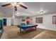 Open game room with guitar wall decor, window views, and custom pool table at 21720 E Domingo Rd, Queen Creek, AZ 85142