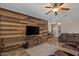 Comfortable living room with a wood-paneled accent wall, tile floors, and easy access to the foyer at 21720 E Domingo Rd, Queen Creek, AZ 85142