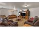 Spacious living room with plush leather seating, large entertainment center, and cozy lighting at 21720 E Domingo Rd, Queen Creek, AZ 85142