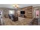 Cozy living room with wood-paneled accent wall, comfortable seating, and tile floors for relaxed living at 21720 E Domingo Rd, Queen Creek, AZ 85142