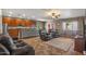 Open-concept living room and kitchen area featuring tile floors, comfortable seating, and natural light at 21720 E Domingo Rd, Queen Creek, AZ 85142