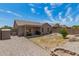 Large backyard featuring a covered patio, a shed and desert landscaping at 22544 W Mohave St, Buckeye, AZ 85326