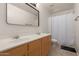 Bathroom with dual sinks, wood cabinets, and tile flooring at 22544 W Mohave St, Buckeye, AZ 85326