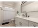 Bright bathroom showcasing a modern vanity, decorative mirror and tiled floors at 22544 W Mohave St, Buckeye, AZ 85326