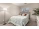 Bedroom with a comfortable bed, lamp, and an abundance of natural light at 22544 W Mohave St, Buckeye, AZ 85326