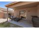 Secluded covered patio area with outdoor seating and a cozy place to grill at 22544 W Mohave St, Buckeye, AZ 85326