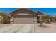 Charming single-Gathering home displaying a two-car garage with stone veneer accents at 22544 W Mohave St, Buckeye, AZ 85326