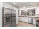Bright kitchen features stainless appliances, sleek white cabinets, and tile flooring at 22544 W Mohave St, Buckeye, AZ 85326