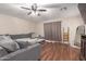 Cozy living room featuring a large sofa, ceiling fan and hardwood floors at 22544 W Mohave St, Buckeye, AZ 85326